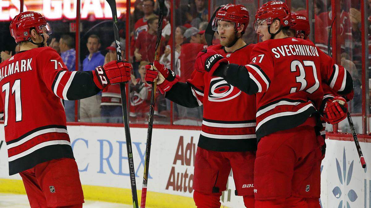 Carolina Hurricanes’ Andrei Svechnikov (37) celebrates his goal with teammates Jaccob Slavin (74) and Lucas Wallmark (71) during the second period of an NHL hockey game, Tuesday, Oct. 9, 2018, in Raleigh, N.C. 