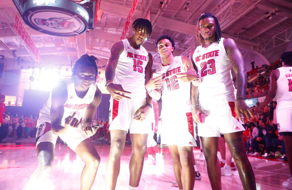 N.C. State’s Cam Hayes (3), Manny Bates (15), Chase Graham (12) and Greg Gantt (23) pose for a photo during Primetime with the Pack at Reynolds Coliseum in Raleigh, N.C., Thursday, October 14, 2021.