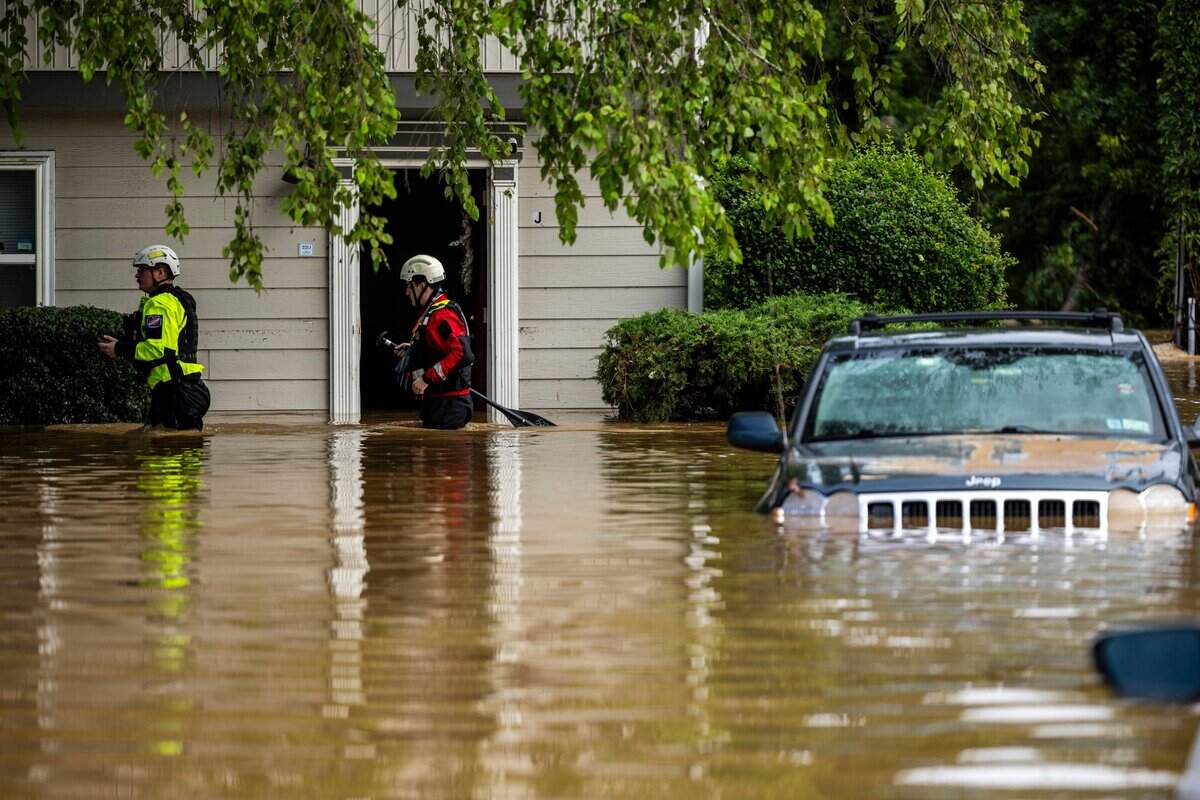 A water rescue unit with the Durham Fire Department knocks on doors at Rippling Streams Townhomes in the Old Farm neighborhood along the Eno River in Durham on Monday morning, July 7, 2025, after flash flooding caused by Tropical Storm Chantal.