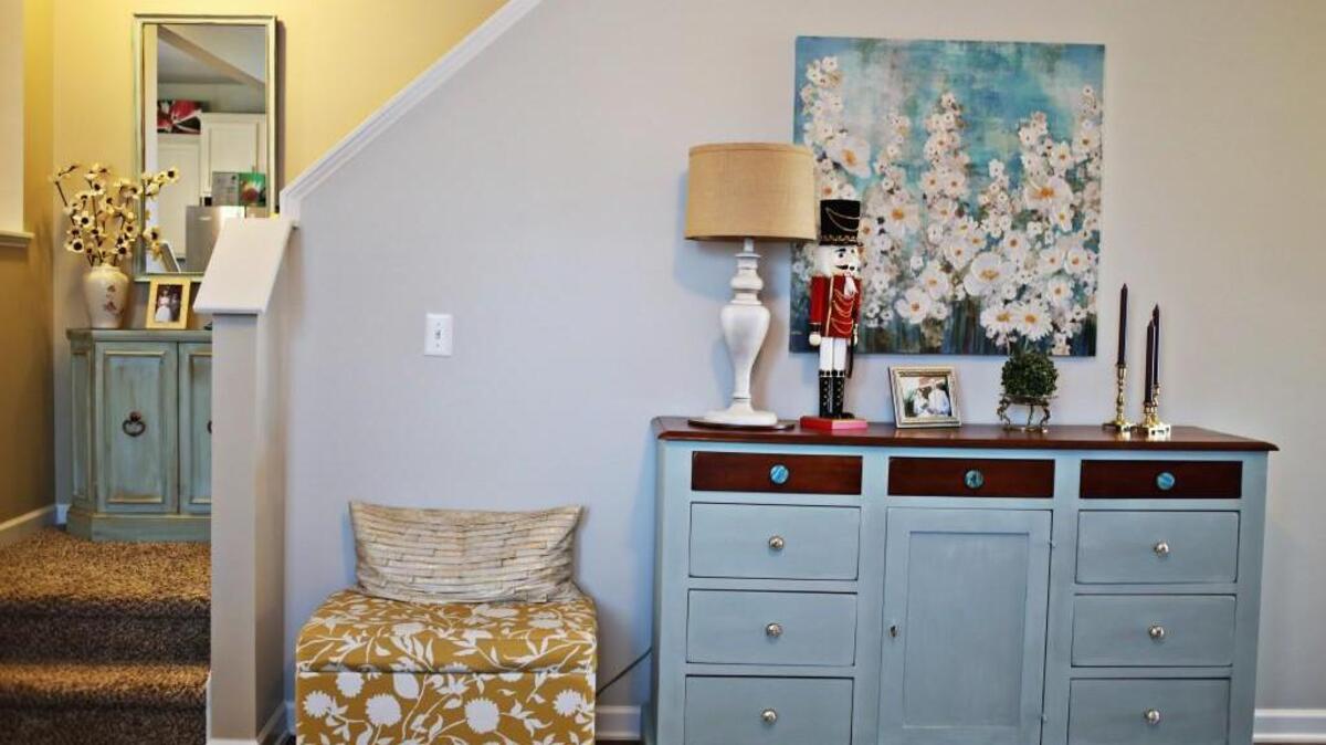 Raleigh working mom Perla Liriano finds old furniture at yard sales and rehabs it in her spare time at her home including the side table on the left and buffet on the right.