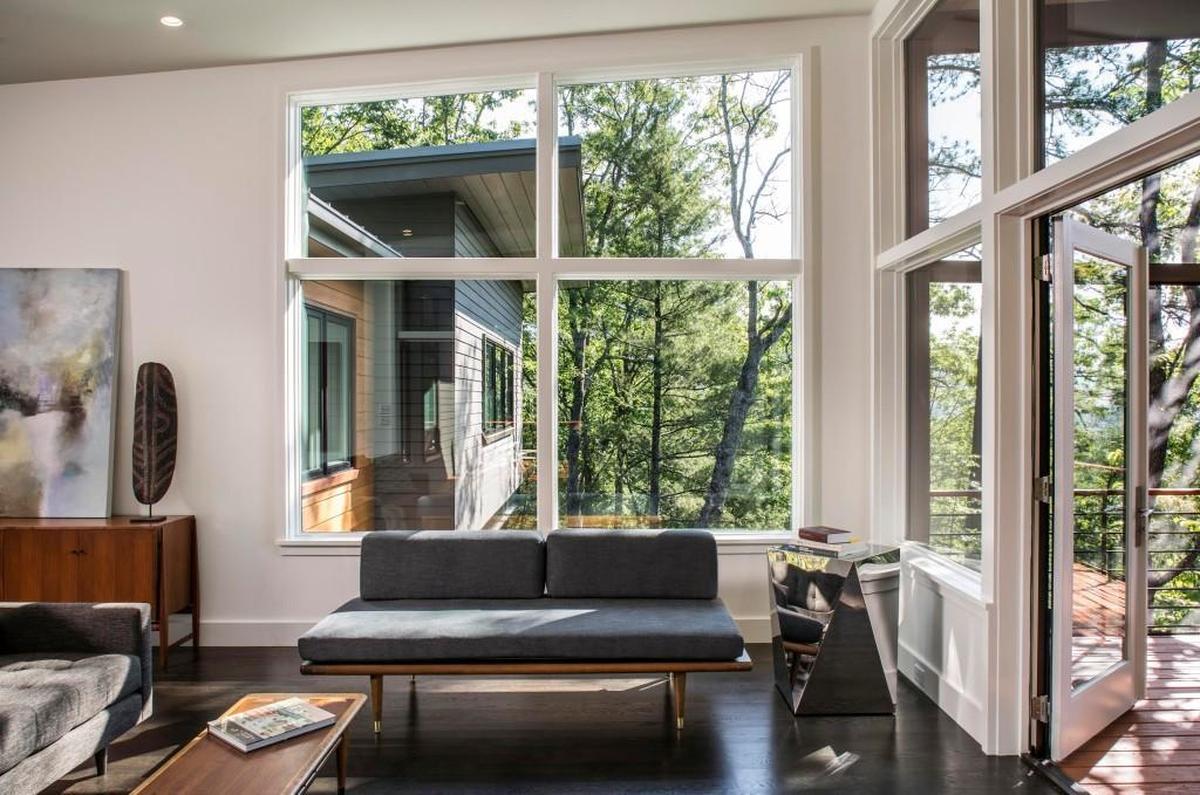 Out on West Chapel Road in Black Mountain near Asheville, architect Scott Huebner carefully positioned a house on a 35-degree slope. He did it with steel beams and heavy timbers. And he maximized mountain views.