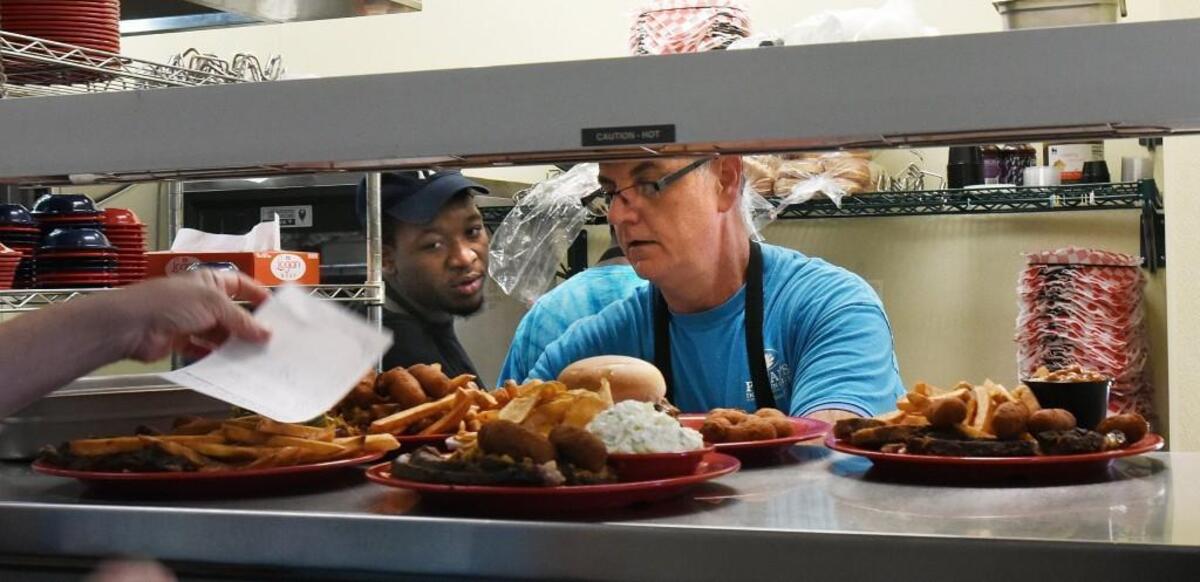 Tim Pattan, right, owner of Pattan’s Downtown Grille, and Josiah Boyce fill orders during a busy lunchtime in Rockingham, N.C., Thursday, May 25, 2017.