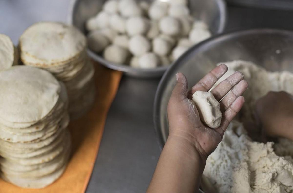 Khisty Angel rolls fresh dough before pressing it into tortillas on Tuesday, July 18, 2017 at Crazy Tacos on S. 5th Avenue in Smithfield, N.C.