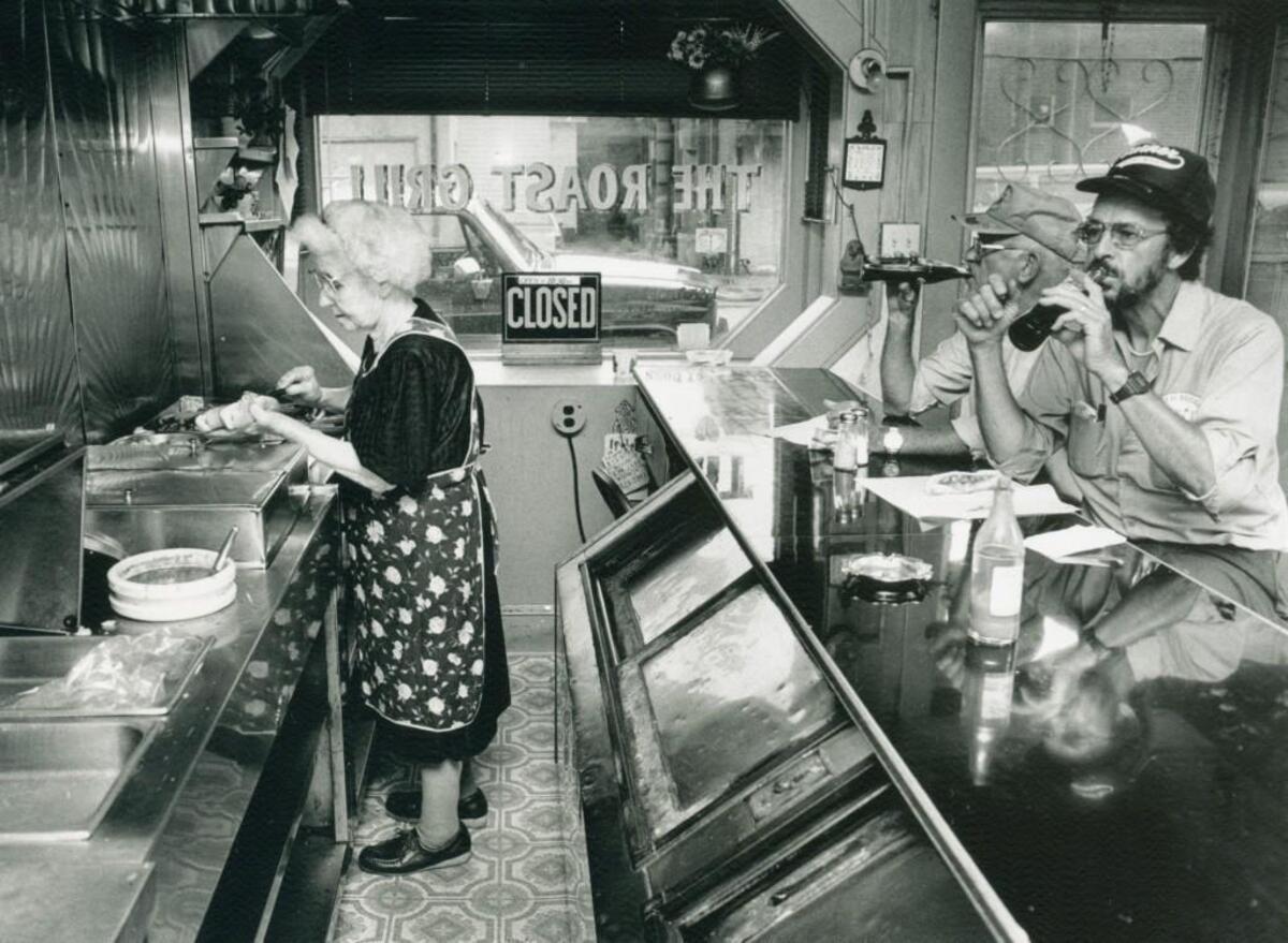 Mary Charles prepares hot dogs at the Roast Grill on West St. during a lunch rush in 1989. The eatery recently posted a Gofundme ad seeking repair costs for the 30-foot cooler.