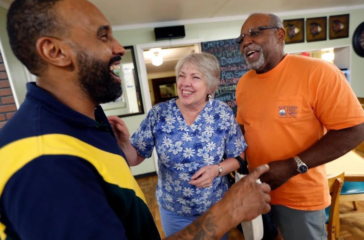 Danny Hayes, owner of the the House of Fish Seafood Restaurant in Aberdeen, left, laughs with customers Brian and Susan Thomas of Pinehurst on June 22, 2017.