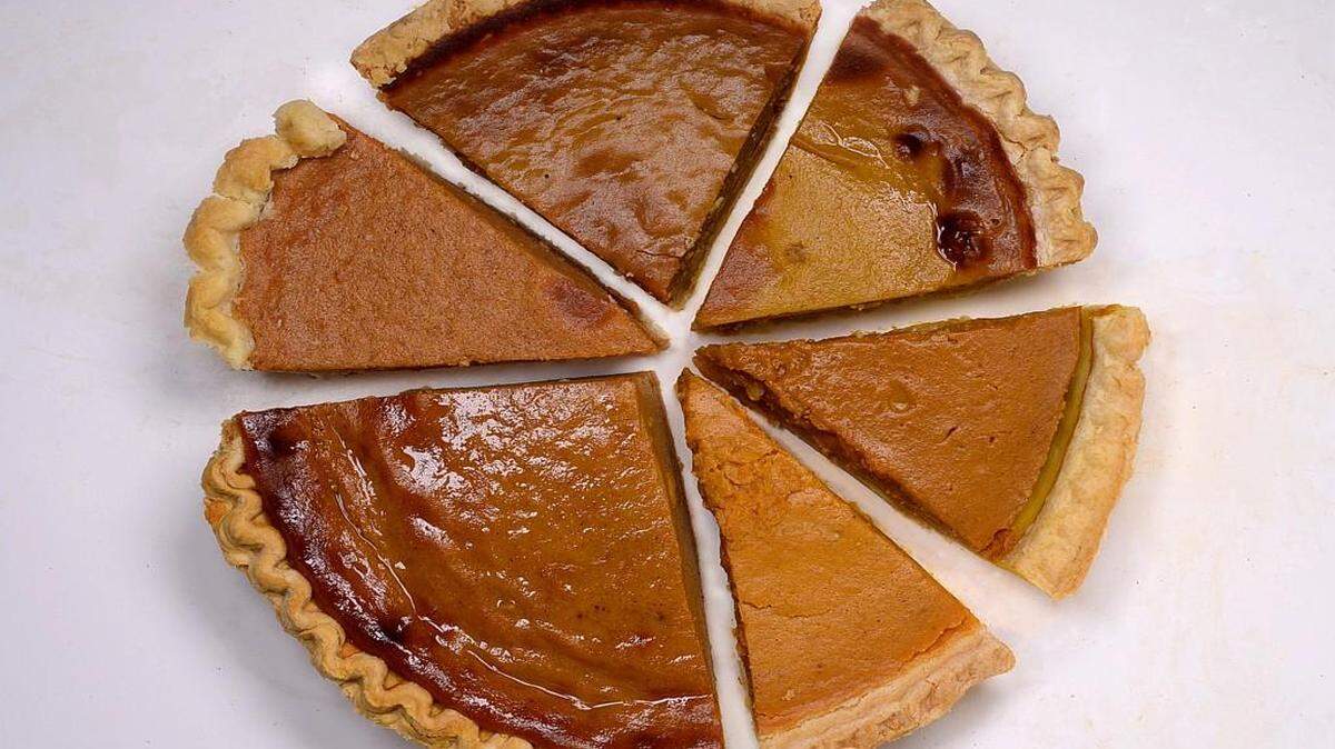Bottom left clockwise are pumpkin pies from Whole Foods (the big piece), Harris Teeter, Fresh Market, Publix, Trader Joe's and Costco (front right).