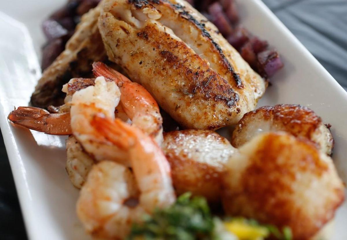 At the House of Fish Seafood Restaurant diners can get grilled striped bass fillet, shrimp and scallops and organic purple potatoes with a mango salsa.