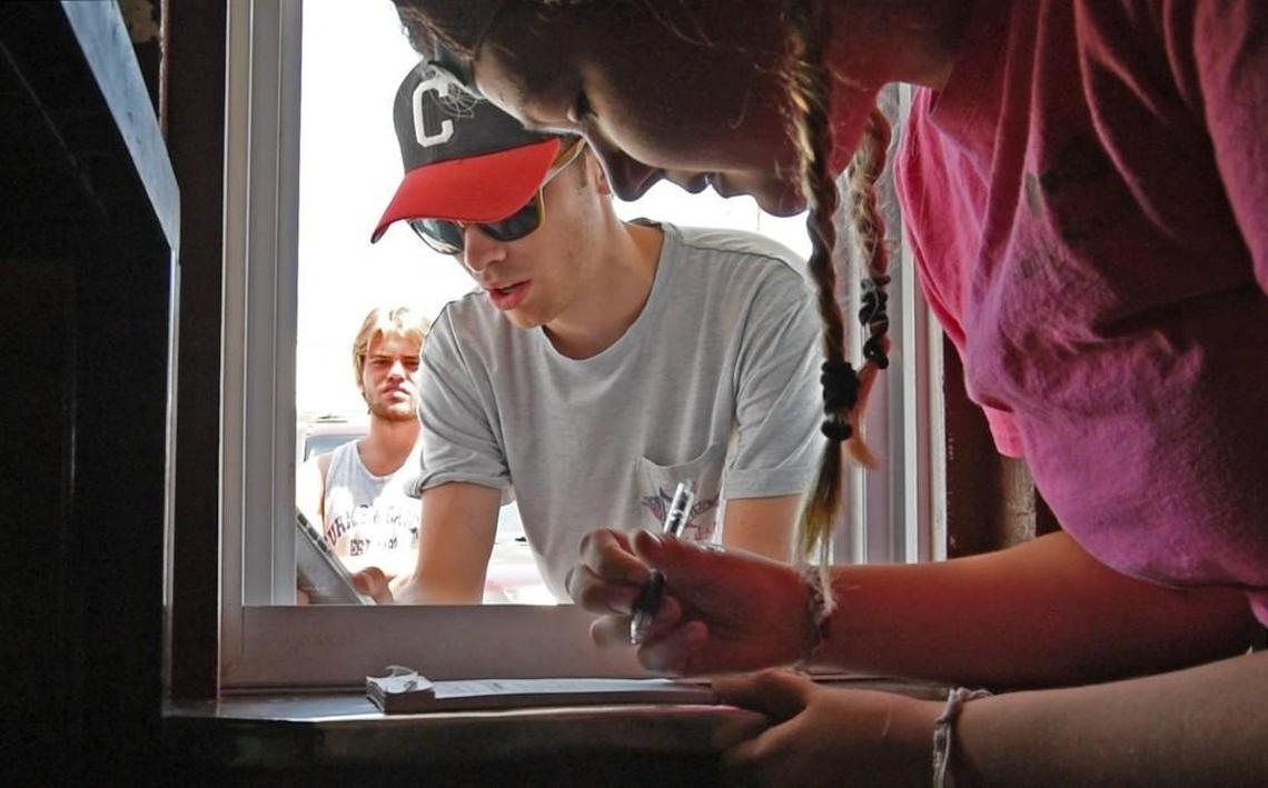 Kaylee Green takes a customer’s order at the window of John’s Drive-In located at Mile Marker 5 in Kitty Hawk, N.C., on Sunday, Aug. 6, 2017. The eatery, located within a stones throw from the ocean, was founded 40 years ago by John Tice, Sr. and is now run by his son John Jr. Family recipes and fresh seafood crowd the menu along with soft serve ice cream.