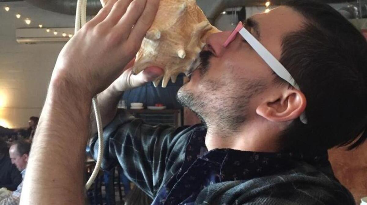 A waiter at Humble Pie in Raleigh blows a conch shell Sunday, March 5, 2017, at noon to signal when the restauraurant can start serving alcoholic drinks, such as mimosas and Bloody Marys.