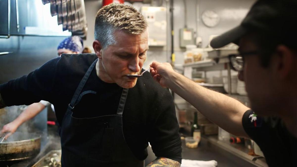 Chef Scott Crawford, left, samples a dish in the kitchen at his Raleigh restaurant, Crawford and Son, on Dec. 7, 2016.