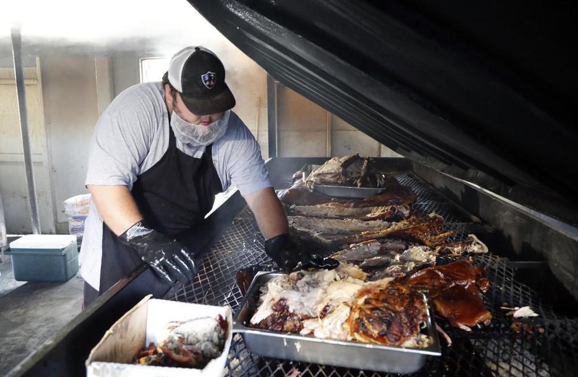 Nicholas Godley pulls the pork off the cooker to bring inside to chop at B's Barbecue in Greenville NC, on June 7, 2017. B's is an old-time barbecue restaurant that ranks near the best in the state in several surveys.