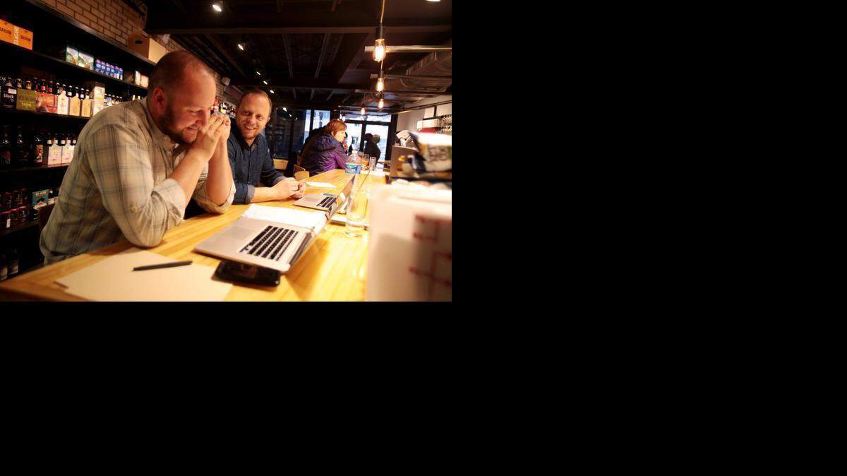 
From left, Woody Lockwood and Chris Powers (two of the guys behind State of Beer) work at the end of the bar in December 2014 at the newly opened State of Beer, a bottle shop, bar and cafe at Harrington and Hillsborough streets. 


