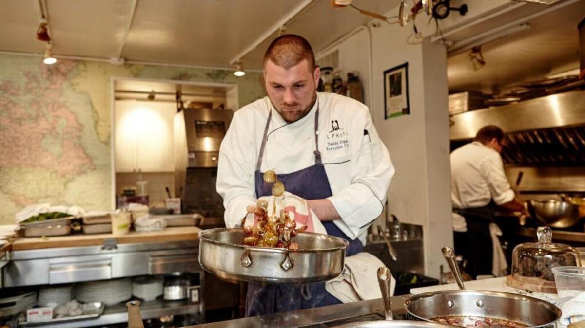 Il Palio Chef Teddy Diggs cooked at the James Beard House in New York City for the first time Feb. 7, 2017. The theme of the dinner was Italian Olive Oil Road Trip. Diggs presented a menu he had prepared three times before at Il Palio, an Italian restaurant inside the Siena Hotel in Chapel Hill. Each course showcases an Italian region and a corresponding olive oil. A picture of James Beard is on the wall behind Diggs.