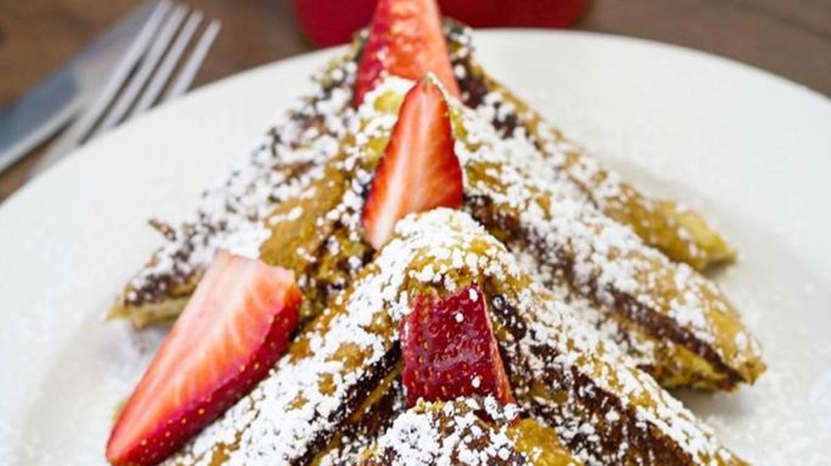 Stuffed strawberry and cream cheese french toast at Famous Toastery. Other stuffed french toast includes raspberry, blueberry and peanut butter and banana.