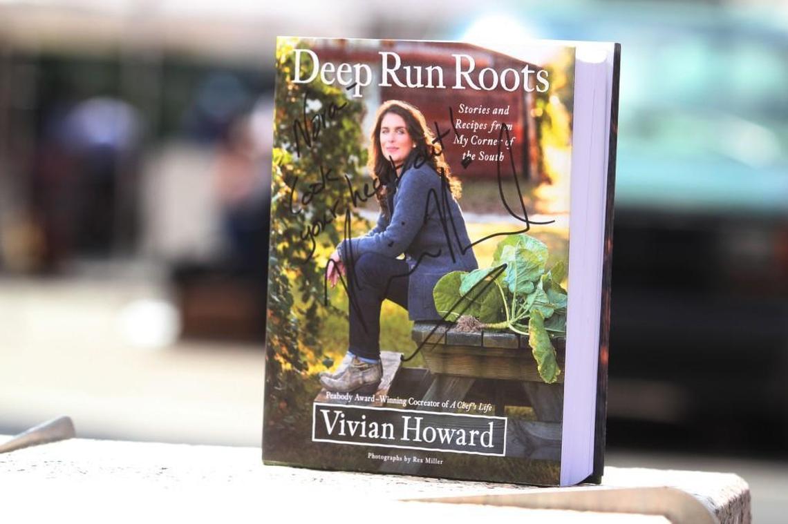 Nora Douglas of Cary asked Vivian Howard to sign the cover of her award-winning cookbook, “Deep Run Roots.” Howard appeared at the Raleigh Downtown Farmers Market Wednesday, July 26, 2017.