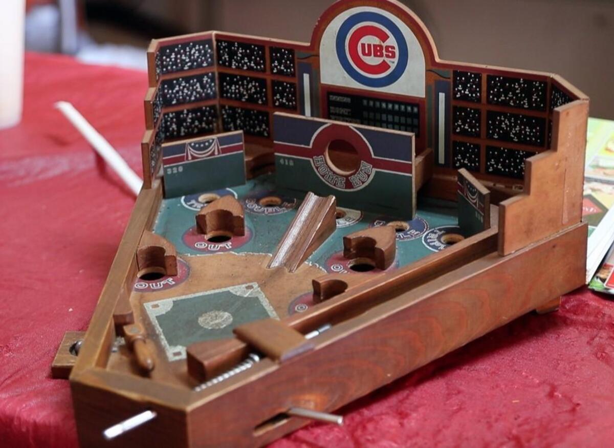 Mike's Chicago Dog (and more) in Asheboro, NC, offers authentic Chicago-style hot dogs. The walls are covered with memorabilia from Chicago sports teams, as well as this old-time Cubs pinball game on the counter. Owner Mike Jones explains the process of making one of the multi-ingredient delicacies and diners enjoy eating at the restaurant on May 18, 2017.