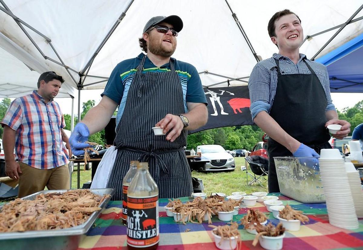 At the Farm to Fork Picnic on June 3, farmers and chefs are paired together to create dishes that celebrate locally sourced food. In 2015, Wyatt Dickson, left, and Ben Adams of Picnic prepared samples of their BBQ.