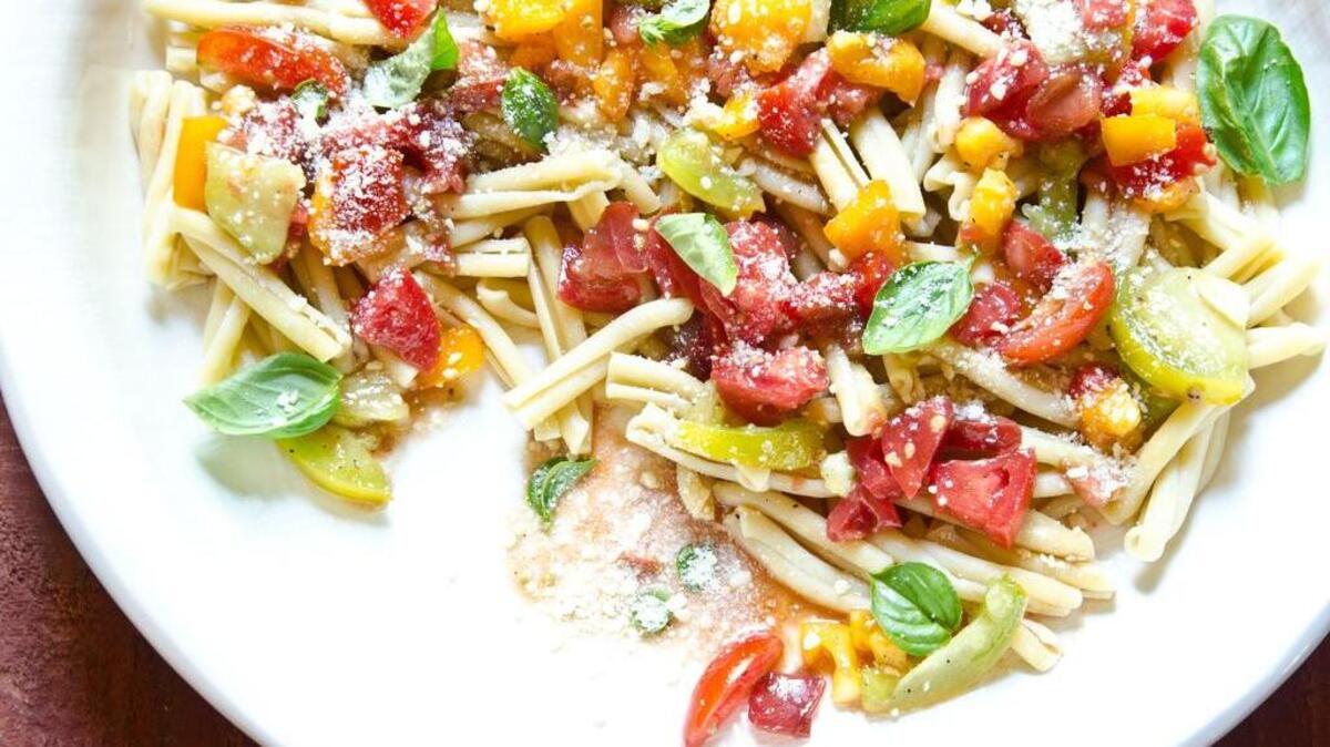 Raw tomato sauce over pasta makes for a refreshing summer recipe.