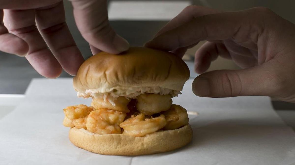 Cain Harvey constructs a shrimp burger at the White Point Take Out on Thursday, June 8, 2017 in Atlantic, N.C. The small take-out only restaurant in rural Carteret County specializes in seafood, burgers and a variety of home- made items.
