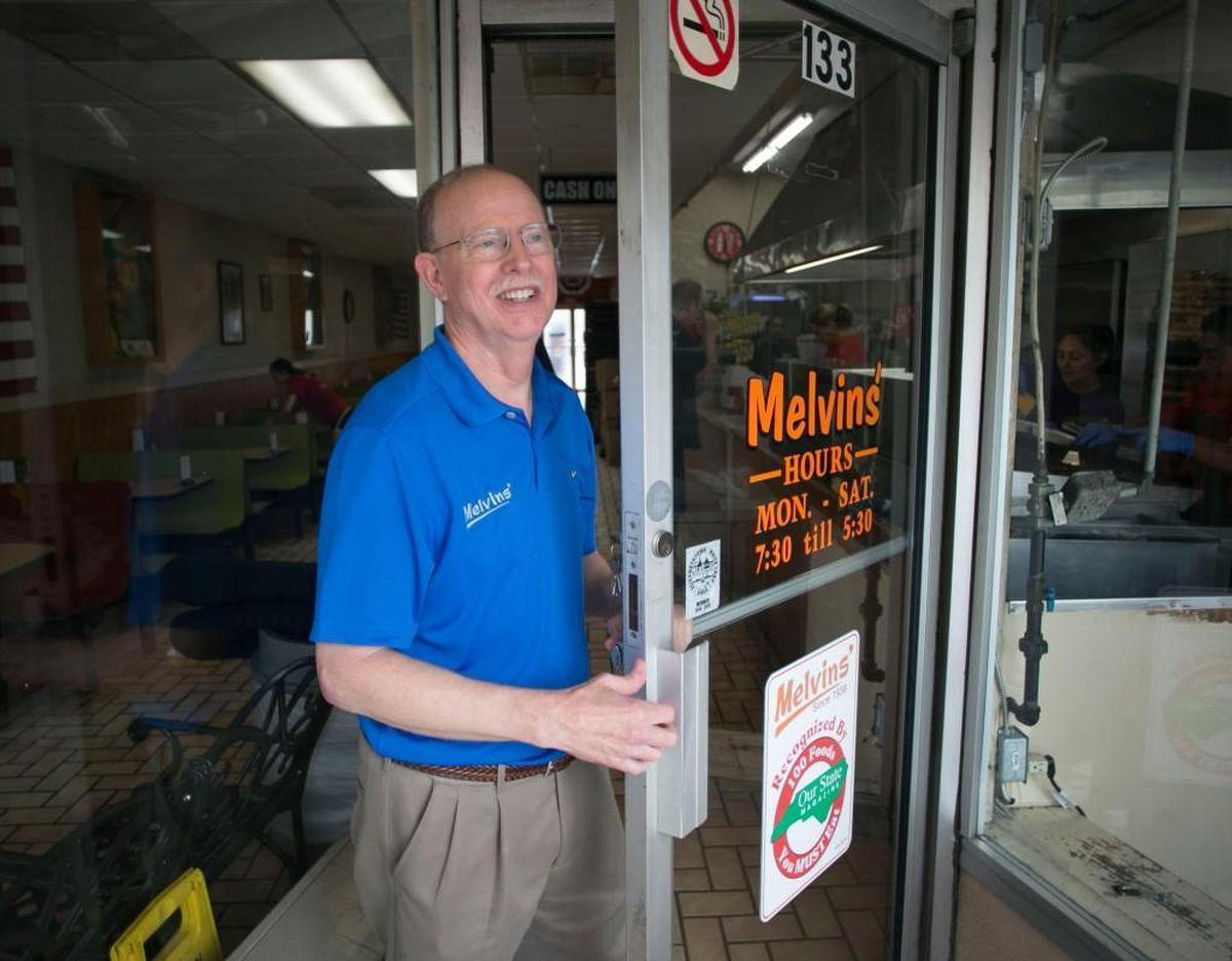 Melvins’ owner Randy Harris prepares to lock the front door at the end of another busy day on Friday, June 30, 2017 in Elizabethtown, N.C.