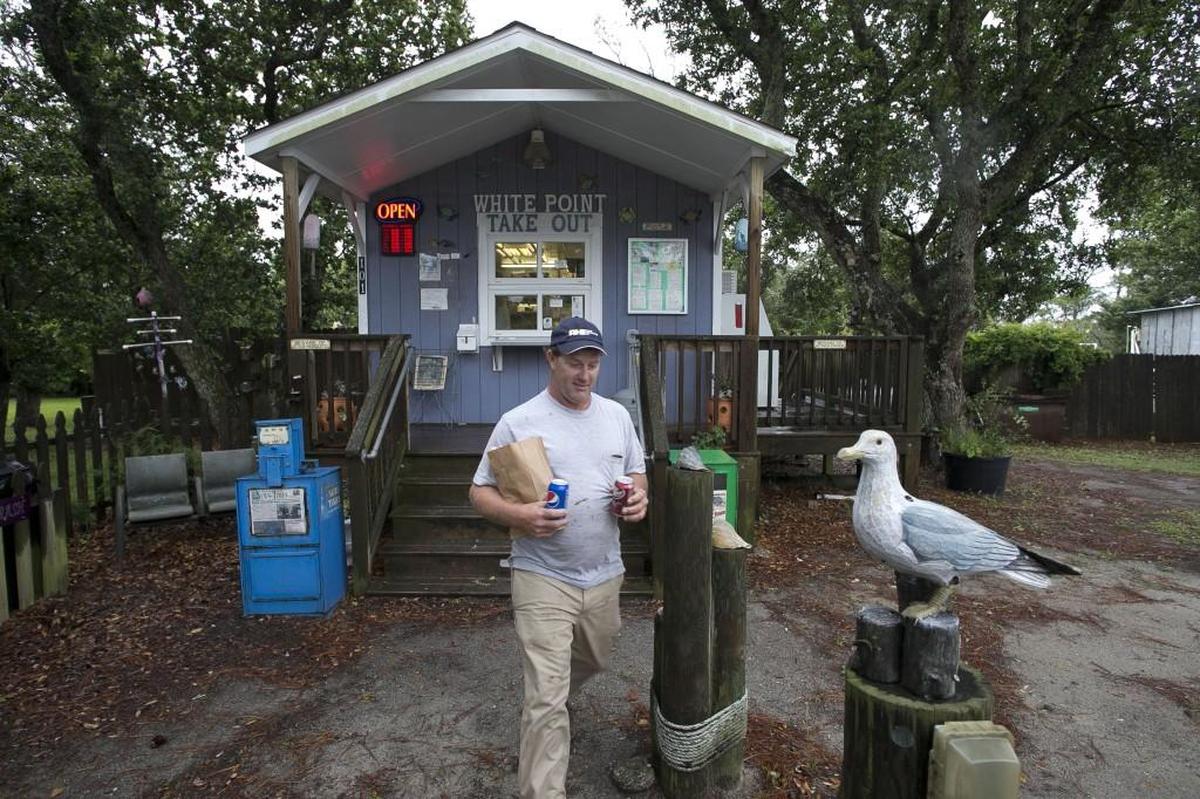 Jason Gillikin of Williston, N.C. picks up burgers for lunch at the White Point Take Out on Thursday, June 8, 2017 in Atlantic, N.C.