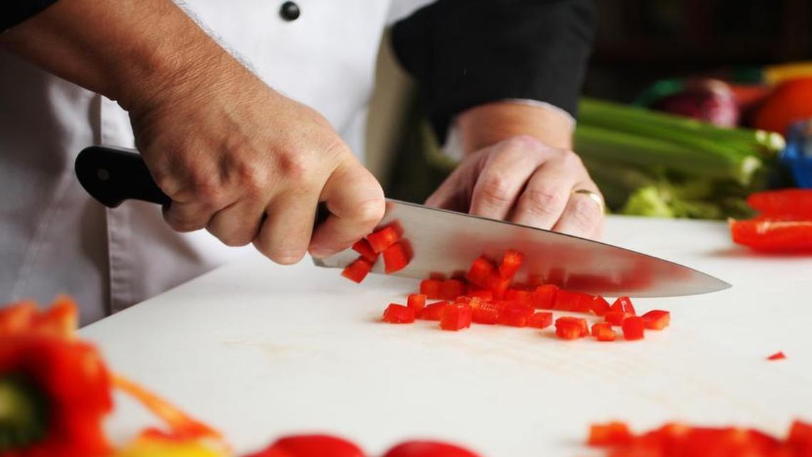 
Chef Brian Adornetto dices peppers after removing the sides of the pepper in one piece. There are various techniques used to chop vegetables, based on their shape.
