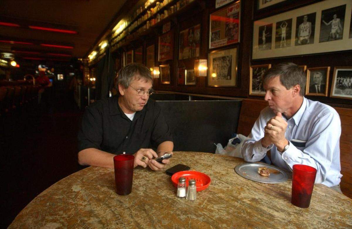 Gus Gusler (left), owner of the Players Retreat, chats with Phil Brown (right) as Brown has lunch at the establishment. The Players Retreat celebrates 65 years on Feb. 27 with a black tie event.