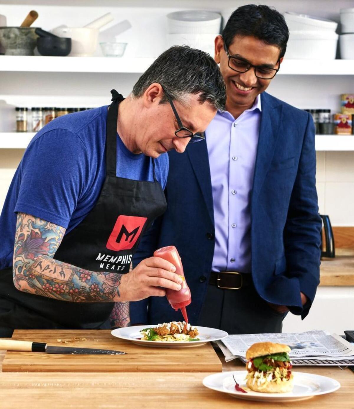 Uma Valeti, CEO and co-founder of Memphis Meats, watches as a chef prepares a Southern fried chicken dish made with Memphis Meats’ poultry product grown from animal cells.