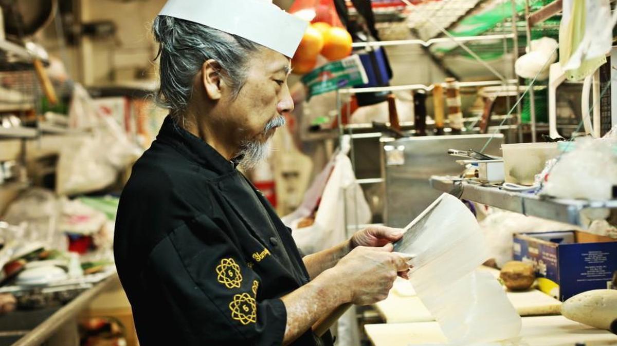 George Yamazawa demonstrates a highly-skilled technique called katsuramuki to cut daikon radish into paper-thin sheets to create a long scroll in his Durham restaurant, Yamazushi, on Friday, Oct. 23, 2015. The restaurant focuses on kaiseki dining is a highly refined form of multi-course dining where every detail of the meal is artfully orchestrated, and nothing happens without careful thought and intentional purpose.