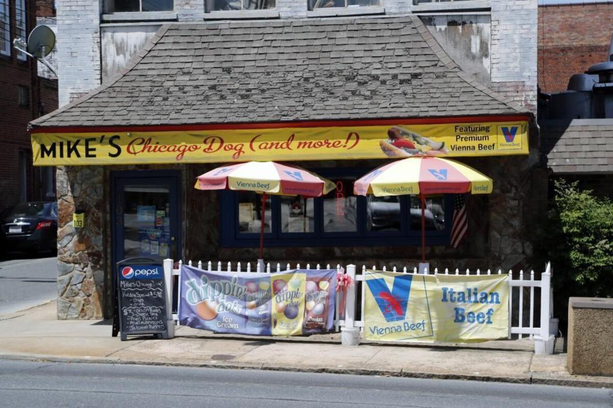Mike's Chicago Dog (and more) in Asheboro, NC, offers authentic Chicago-style hot dogs. The walls are covered with memorabilia from Chicago sports teams. Owner Mike Jones explains the process of making one of the multi-ingredient delicacies and diners enjoy eating them at the restaurant on May 18, 2017.