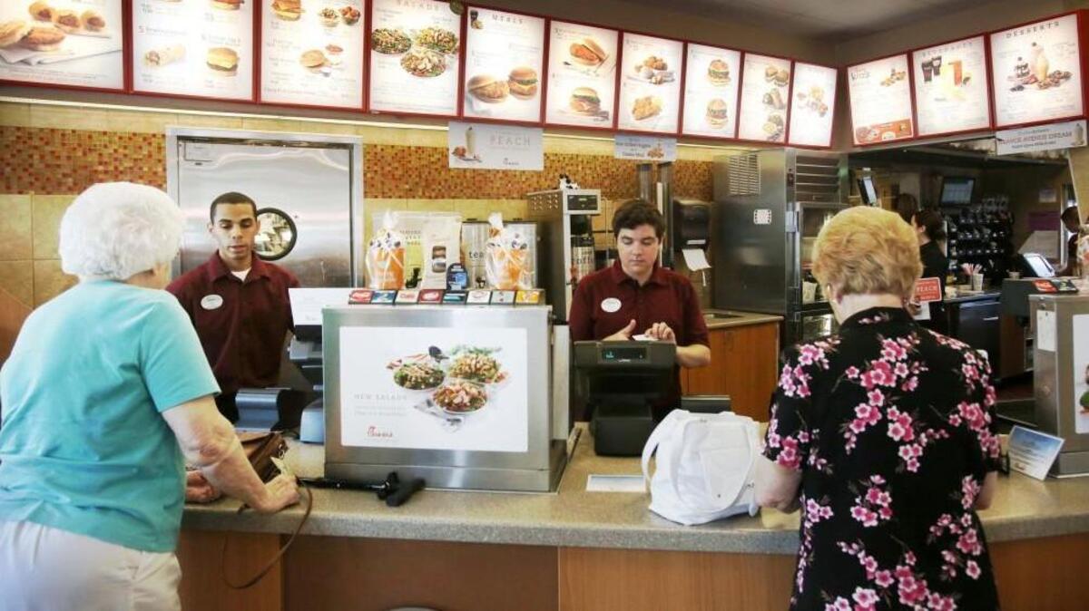 Customers place orders at a Chick-fil-A in Orlando.