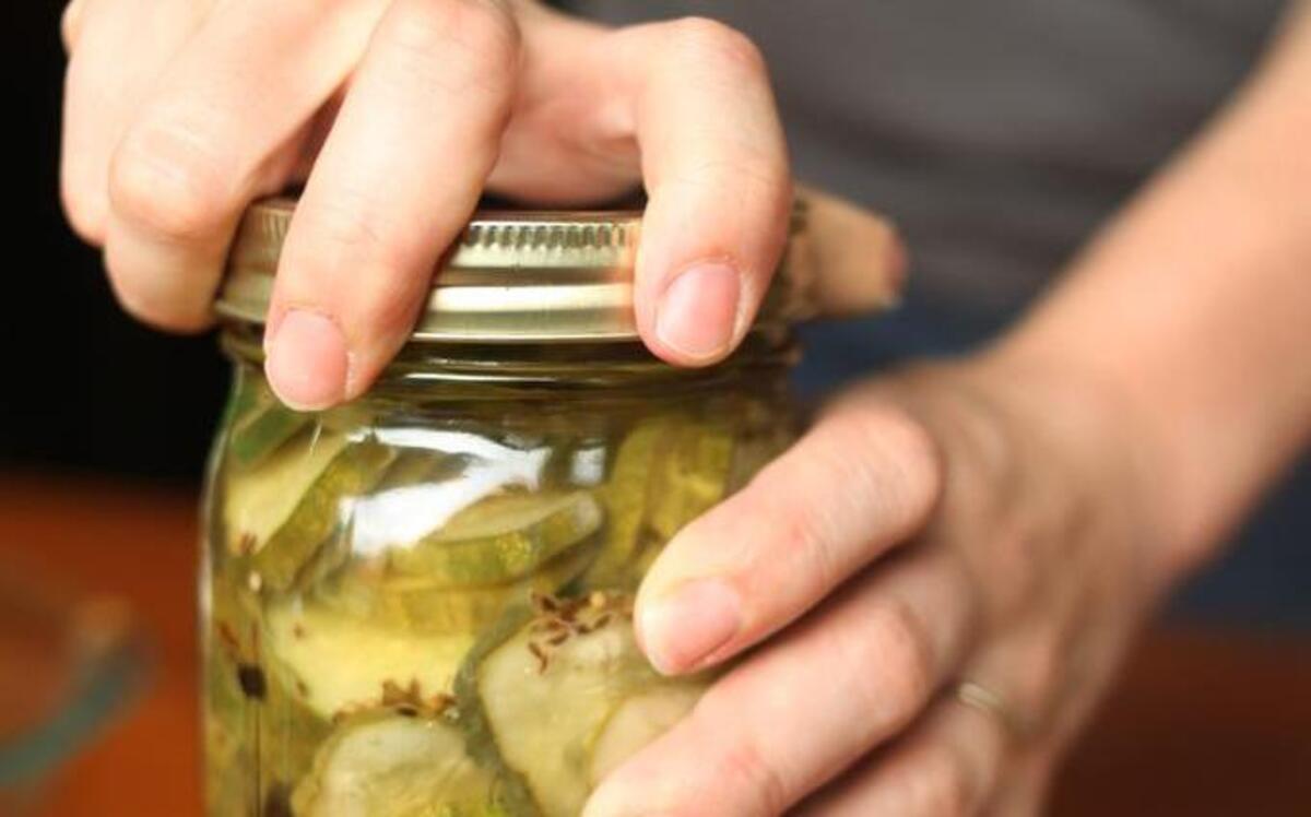 
The final step for making refrigerated dill slices is completed before placing the jars in the refrigerator for at least two days to allow the cucumber slices to marinate.
