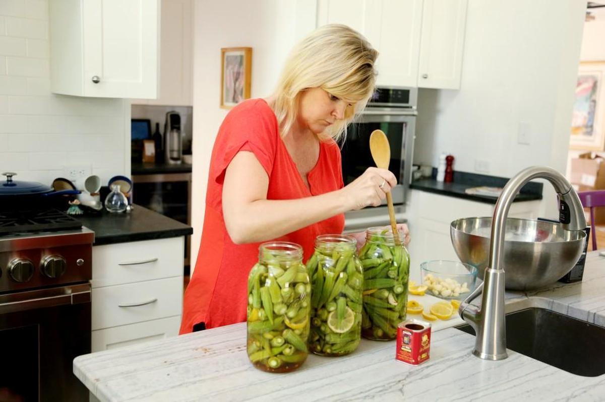 Jamie DeMent, who recently released her cookbook, "The Farmhouse Chef : Recipes and Stories from My Carolina Farm," pickles okra from her late summer garden Wednesday, Aug. 23, 2017, at her Hillsborough farm, Coon Rock Farm.