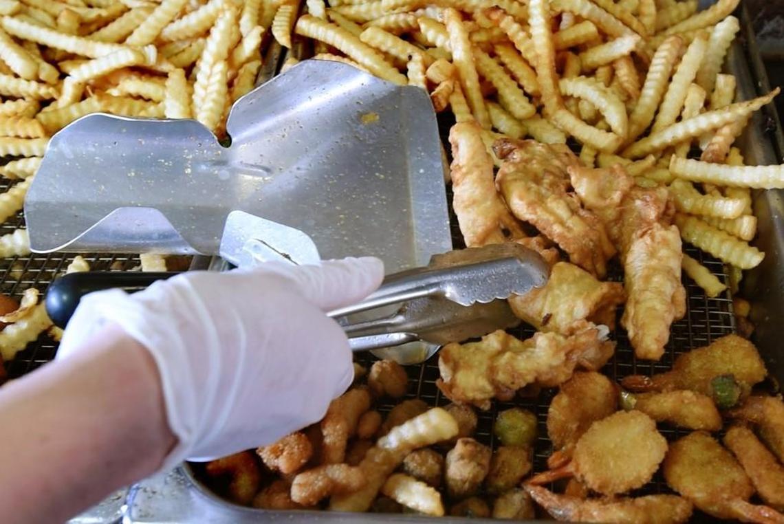 Fried dolphin, crab cakes, shrimp and grouper along with a copious amount of fries await delivery at John’s Drive-In located at Mile Marker 5 in Kitty Hawk, N.C., on Sunday, Aug. 6, 2017.