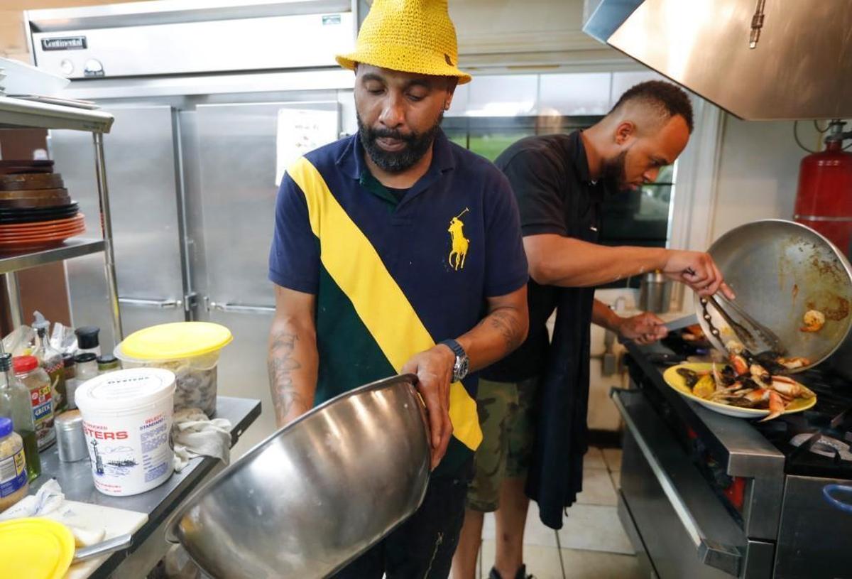 Danny Hayes, left, owner of the House of Fish Seafood Restaurant in Aberdeen, cooks with Bernard Smith in the kitchen Thursday, June 22, 2017.