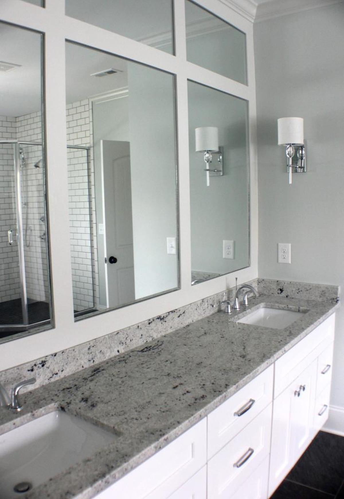 This bathroom integrates new construction selections and a custom mirror design. If you are planning to sell your home in the near future, make your money count. Don’t overspend on expensive, trendy finishes. It’s best to select timeless materials at an affordable price point. Examples include neutral paint, chrome metals and hardwood flooring.