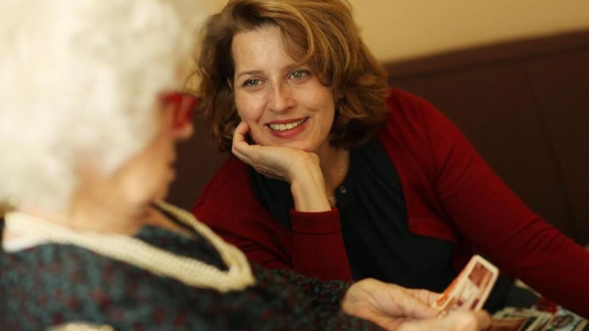 Rosemary Miller, left, and her daughter, Mary Miller, look over Christmas photos from Mary's childhood on Wednesday, Dec. 16, 2015, at Hillside Nursing and Rehab in Wake Forest.