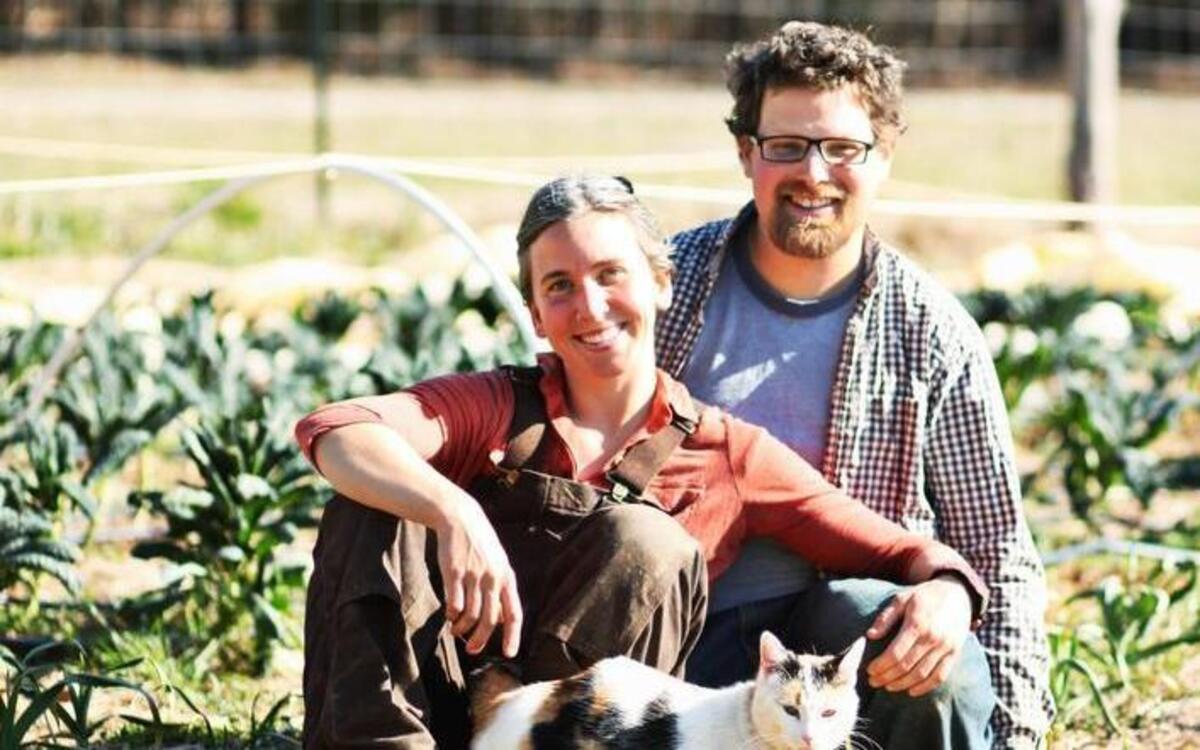 Tracey Slaughter and Will Cramer with their cat, Kelly, at their Ever Laughter Farm in Hillsborough.