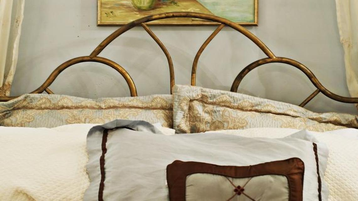 Anna Mangum's bedroom, decorated in a "Southern romantic" style, has chandeliers, rugs, pillows and artwork found in second-hand stores.