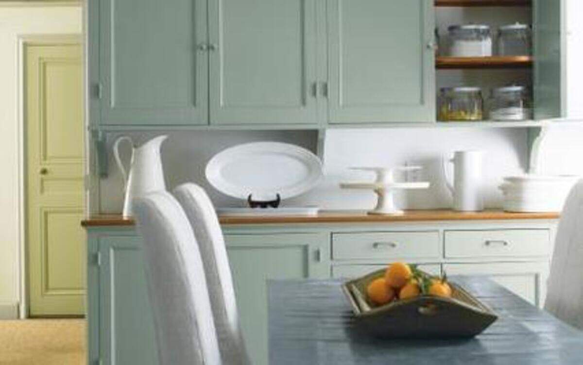 
Color cabinets mixed with natural wood counter tops create a warm and inviting space. The cabinets paint color is Maid of the Mist.
