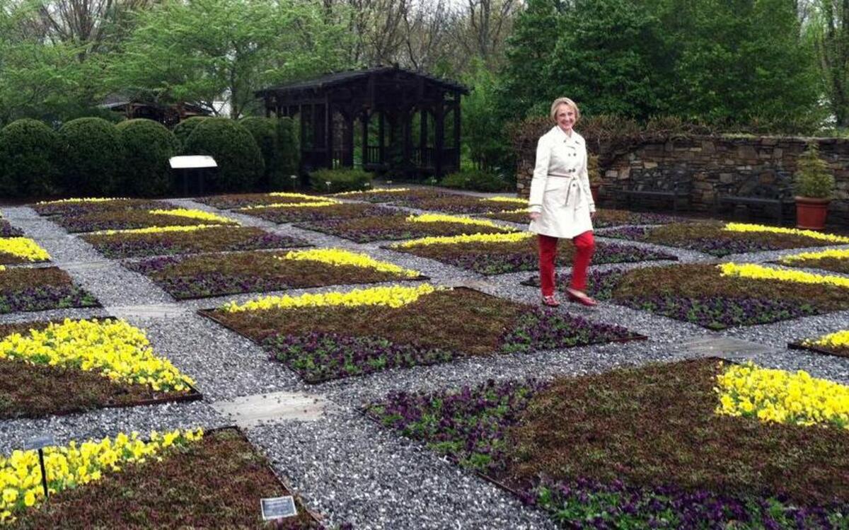 
This April 20, 2015 photo shows Clara Curtis, director of design and education at the North Carolina Arboretum in Asheville, N.C., walking in the arboretum's quilt garden. The garden is planted each year in the design of a traditional quilt block pattern to connect the garden to the region's Southern Appalachian heritage.
