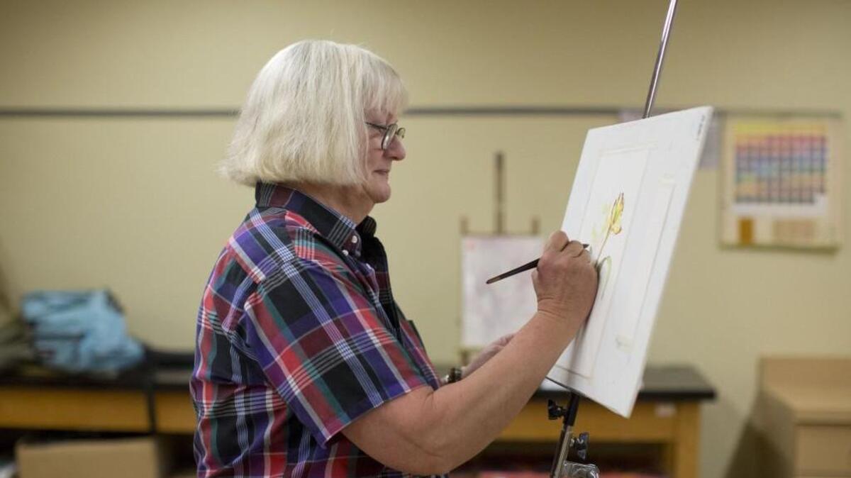 Laura Azzi, an instructor at the craft center, paints using watercolors at the NC Craft Center. Public registration is now open for classes.