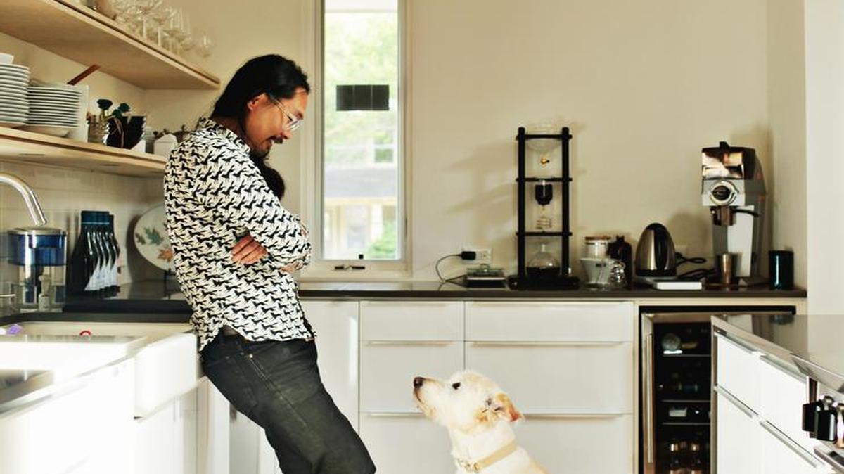 
Joe Kwon with his dog, Buckley, in his new kitchen in downtown Raleigh on Monday, May 25, 2015. Kwon, the cellist of The Avett Brothers, got to do what every obsessive home cook dreams about: design his own kitchen.
