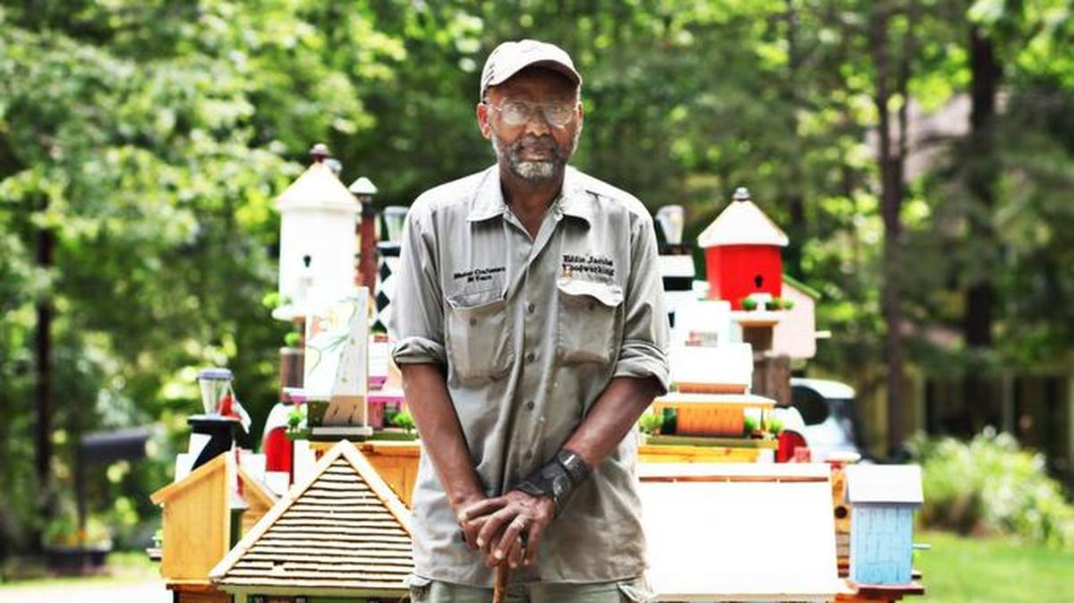 Eddie Jacobs stands near his pick-up truck and trailer filled with his homemade birdhouses on Tuesday, May 31, 2016. Jacobs started making a variety of birdhouses two years ago, all influenced by North Carolina history.