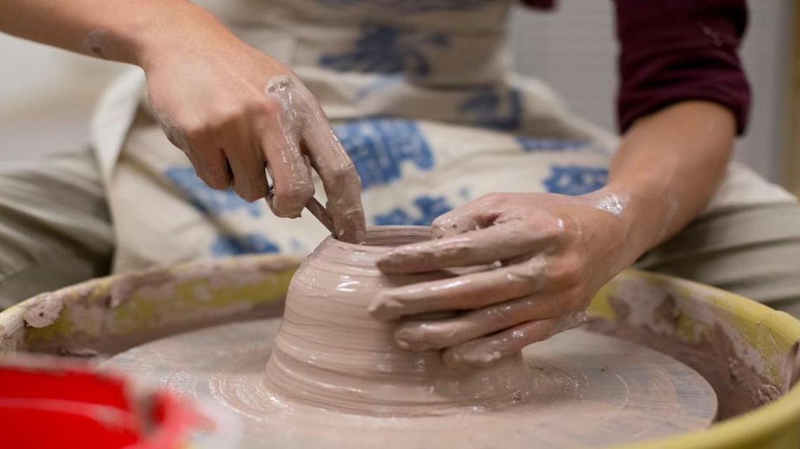 
Wah Tran, a student instructor, works on the pottery wheel during the craft fair at the NC Craft Center Tuesday, August 18, 2015 in Raleigh, N.C.
