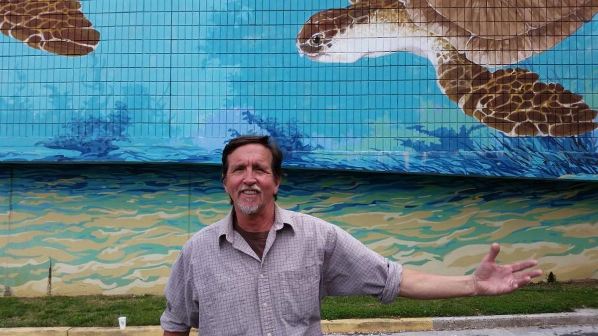 Michael Brown, pictured in 2016, has painted numerous murals in Chapel Hill, including the “Sea Turtles” on North Columbia Street. In 2021, the mural and the parking deck on which it was painted were demolished.