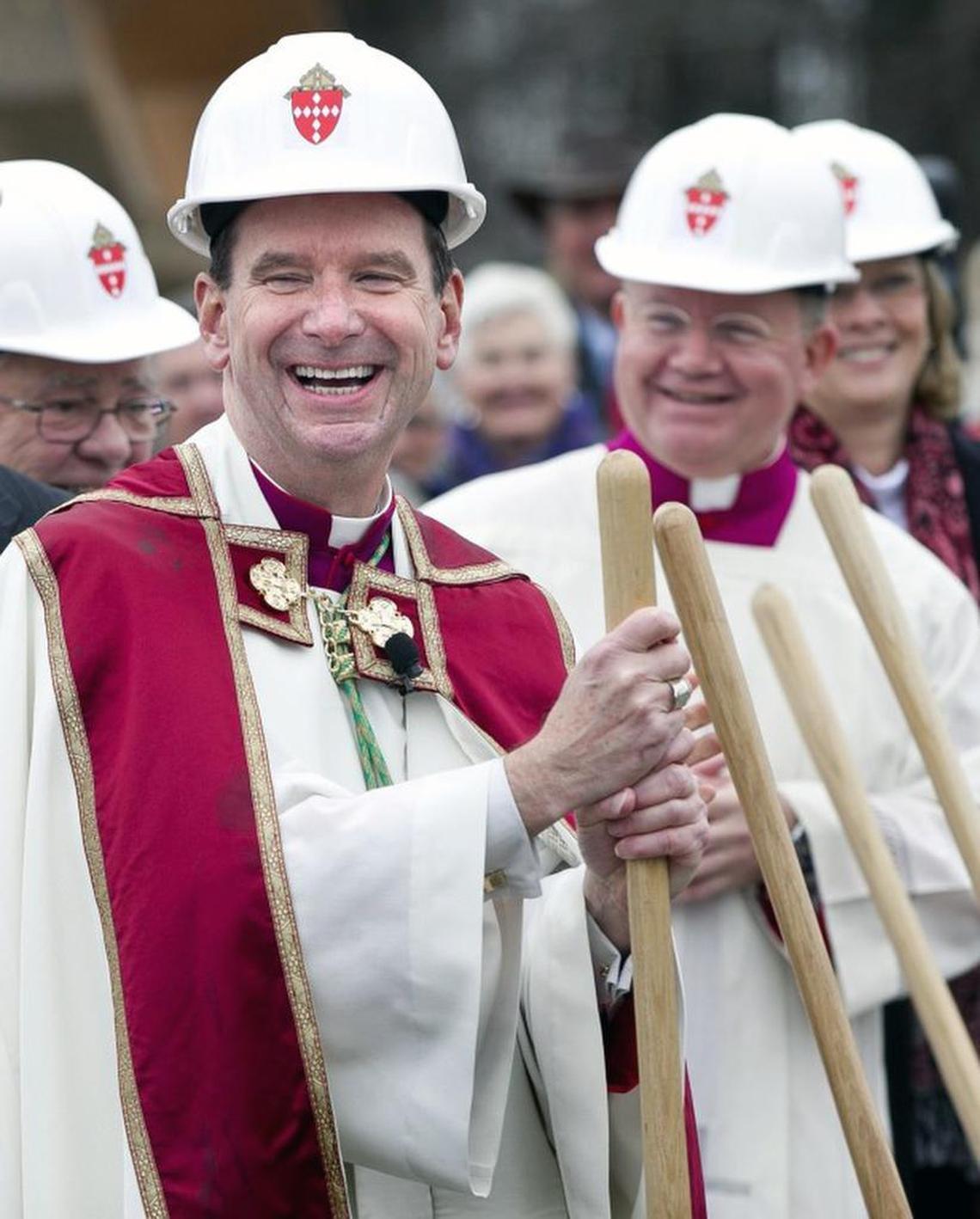 Bishop Michael F. Burbidge laughs after joking about a completion date for the Holy Name of Jesus Cathedral with the contractor during a groundbreaking on Saturday, January 3, 2015 in Raleigh, N.C.