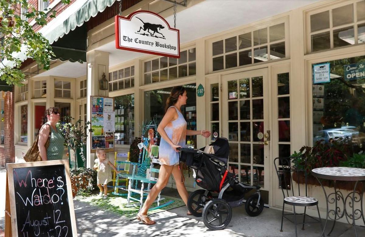 Parents and kids enter the main door of The Country Bookshop on West Broad Street in downtown Southern Pines, NC in August 2016.