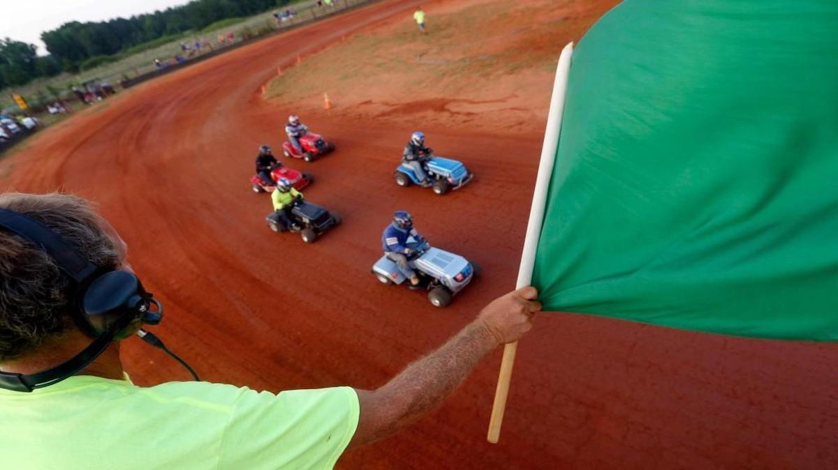 Wayne Taylor signals the start of a race during Ellerbe Lions Club Lawn Mower Racing. On a good night, Taylor said, up to 40 people race in varying age groups.