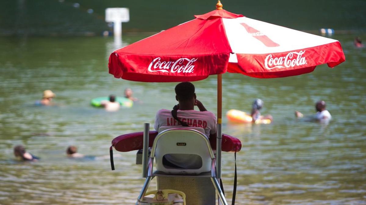 Willie Smith, 19, watches from his lifeguard stand as families play in the lake at Cliffs of the Neuse State Park in Seven Springs on July 24, 2015.